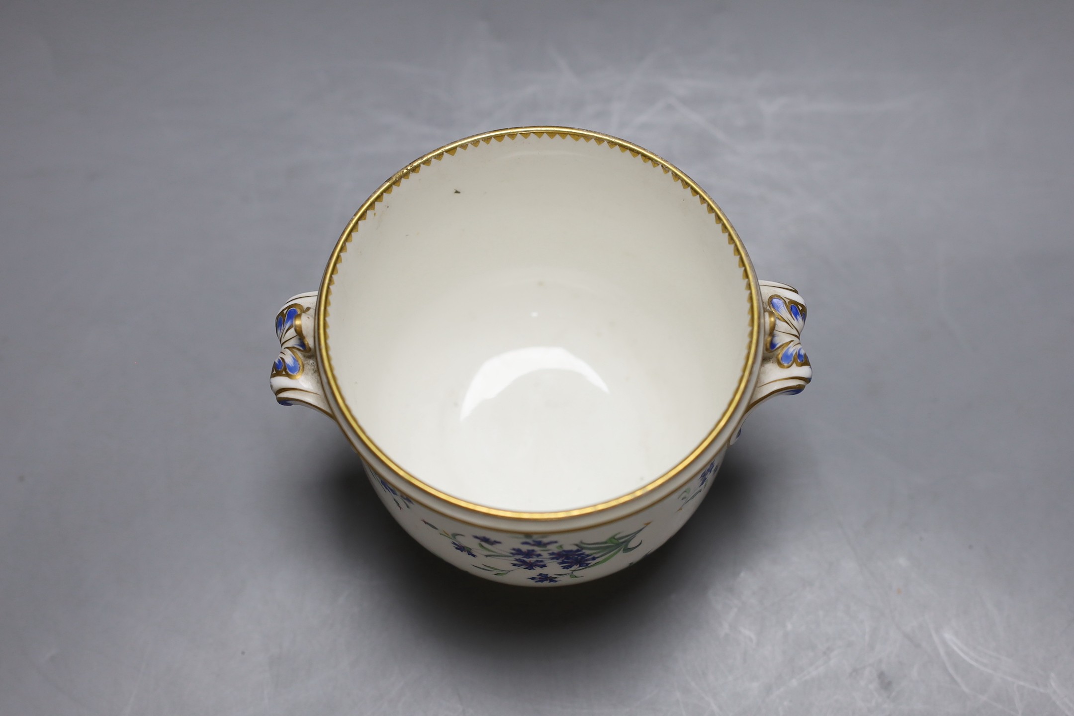 An early 19th century Paris porcelain cache pot or glass cooler with two handles painted with corrnflowers, 9.5 cms high
